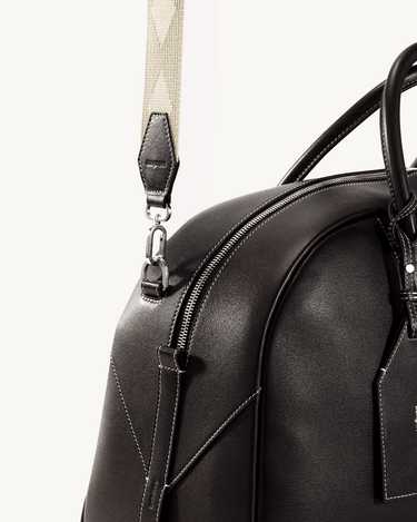 Large Yore black full-grain Nappa leather bowling bag with contrasting white stitching and SS 304 hardware.