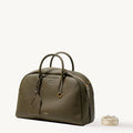 Large Moss Yore Bowling Bag with textured leather and detachable patterned strap.