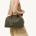 Large Yore Bowling Bag in Moss green full-grain leather with diamond motif tag and gold hardware.