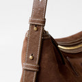 Large Yore Hobo Bag in Sandal Suede. Detailed view of the adjustable strap with white stitching and metal hardware.