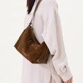 Large Yore Hobo Bag (Minimal Version) in Sandal Suede, a brown cow suede leather hobo bag worn by a woman.