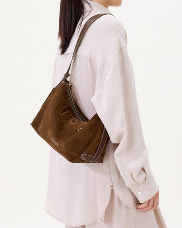 Large Yore Hobo Bag (Minimal Version) in Sandal Suede, a brown cow suede leather hobo bag worn by a woman.