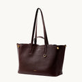 Large Yore Tote Bag in Raisin color, made of pebble-grained leather with gold hardware.