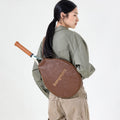Brown vegetable-tanned leather tennis racket cover with "Songmont" embossed