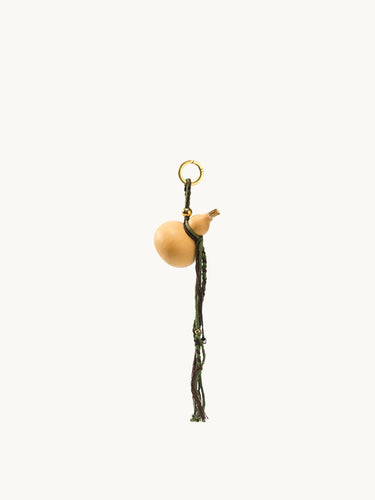 Lucky Gourd Charm in Cypress: natural gourd, braided cord, gold keyring. Symbol of luck and wealth.