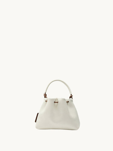 Lucky Pouch Charm, white full-grain nappa leather drawstring bag with adjustable strap.