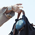 Lucky Pouch Charm bag with leather strap, drawstring closure, and denim accent pouch, made of fabric and leather.