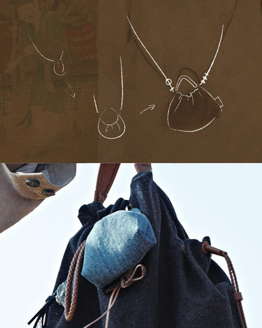 Lucky Pouch Charm in dark grey fabric with leather strap and a small denim accessory.
