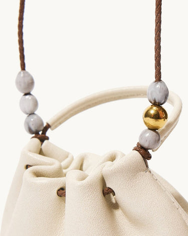 Cream leather Lucky Pouch Charm with grey and gold bead detail on strap