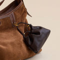 Lucky Pouch Charm: Brown suede shoulder bag with dark brown leather pouch, adjustable strap.