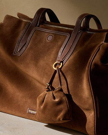 Brown suede duffel bag with leather trim and a small pouch, featuring the Songmon logo.