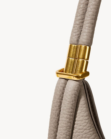 Luna Bag in Cobble color with textured leather strap and gold hardware featuring 'SONGMONT' logo.