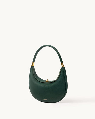 Emerald green Luna Bag in textured full-grain leather with gold hardware, showcasing a curved silhouette and elegant design.
