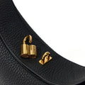 Black pebbled leather Luna Bag with gold hardware clasp slightly ajar, showcasing "Songmont" engraving.