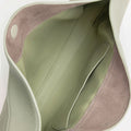 Interior of the Luna Bag showing sage green leather lining with subtle stitching and an open pocket.
