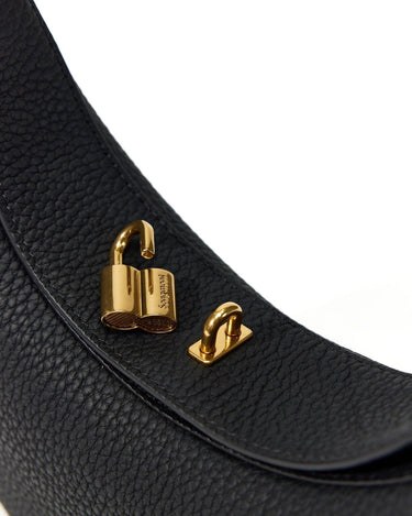 Black leather Luna Bag with gold lock closure detail.