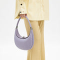 Light purple full-grain leather Luna Bag with SS 304 hardware, held by a hand.