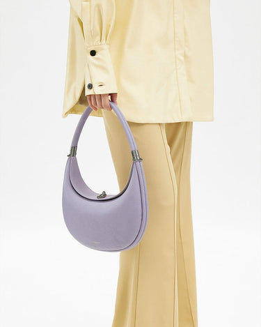 Light purple full-grain leather Luna Bag with SS 304 hardware, held by a hand.