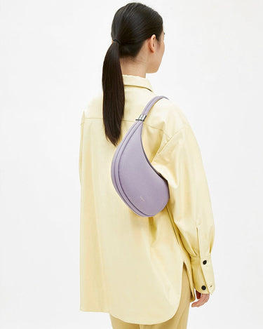 Lavender full-grain leather Luna Bag worn on shoulder