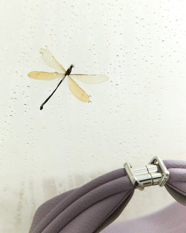 Luna Bag: Full-grain leather accessory with silver hardware clasp, detailed stitching, and dragonfly motif.