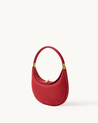 Lucky Red Luna Bag crafted from textured full-grain leather with gold hardware and a magnetic clasp.