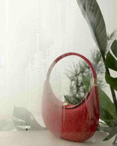 Luna Bag in Lucky Red, textured cowhide leather, crescent shape with gold hardware.
