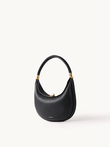Black leather Luna Bag with gold hardware and curved handle.