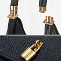 Black leather Luna Bag with gold hardware and magnetic clasp, featuring the Songmont logo.