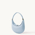 Sky blue Luna Bag crafted from full-grain leather with a silver-tone clasp and adjustable strap.