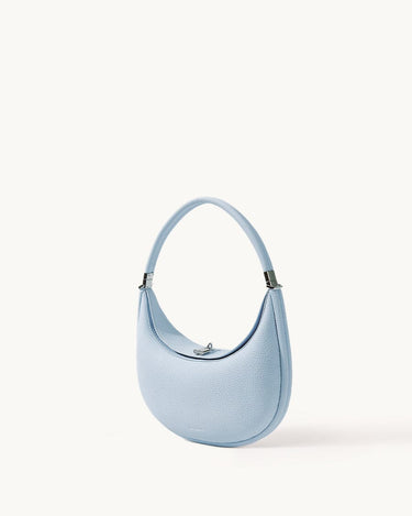 Sky blue Luna Bag crafted from full-grain leather with a silver-tone clasp and adjustable strap.