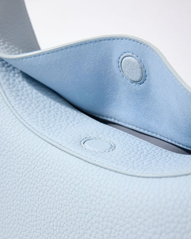 Pale blue leather Luna Bag interior with magnetic snap closure