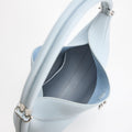 Sky blue Luna Bag made of full-grain leather with a synthetic interior, featuring a rounded handle and silver hardware.