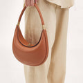 Luna Bag in Eco Caramel vegan leather with gold hardware. Adjustable strap for shoulder, crossbody, or hand carry.