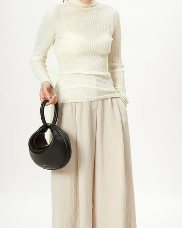 Luna Bag (vegan leather) in Eco Onyx, a black textured handbag with gold clasp.