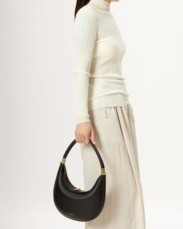 Black vegan leather Luna bag with gold hardware, crescent shape, textured finish, and 'Songmont' embossing.