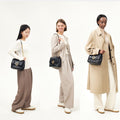 Medium Chocolate Bag in black quilted calf leather with gold chain strap and buckle, shown on models of different heights.