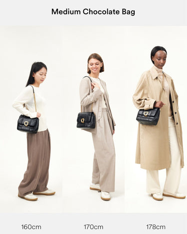 Medium Chocolate Bag in black quilted calf leather with gold chain strap and buckle, shown on models of different heights.