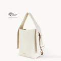 Cream vegan leather tote bag with adjustable strap and Global Recycled Standard certification.