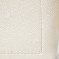 Cream vegan leather medium drippy tote bag, showing textured material and stitched seams.