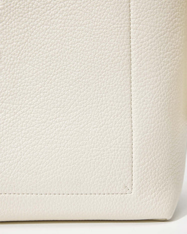 Cream vegan leather medium drippy tote bag, showing textured material and stitched seams.