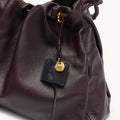 Ebony Medium Gather Bag Set made of full-grain Nappa leather with gold hardware and Songmont logo charm.