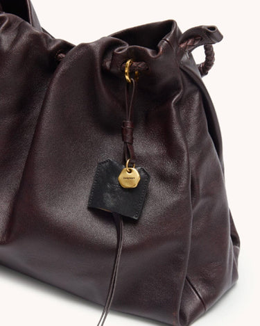 Ebony Medium Gather Bag Set made of full-grain Nappa leather with gold hardware and Songmont logo charm.