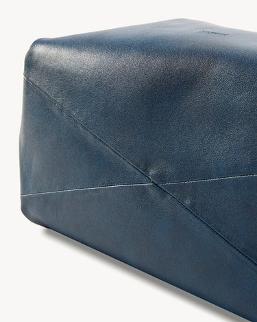 Medium Gather Bag Set in navy blue leather, showing textured material and stitched details.