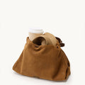 Ochre suede medium gather bag set with coffee cup and straw hat, featuring leather accents and Songmont logo.
