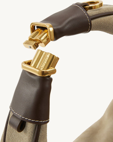 Close-up of Large Luna Hobo Bag's gold clasp mechanism in Dune Suede, showing the Songmont logo.