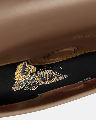 Medium Reset Tofu Bag interior with embroidered butterfly detail in caramel leather