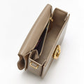 Medium Reset Tofu Bag in Caramel calf leather with gold hardware and interior compartments.