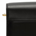 Close-up of a black leather Medium Reset Tofu Bag showing stitching detail and a gold ring.