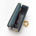 Opened Onyx Medium Reset Tofu Bag with teal interior, gold Wonton ring, and compartments.