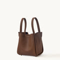 Medium Song Bag in chocolate brown textured full-grain leather with two top handles.